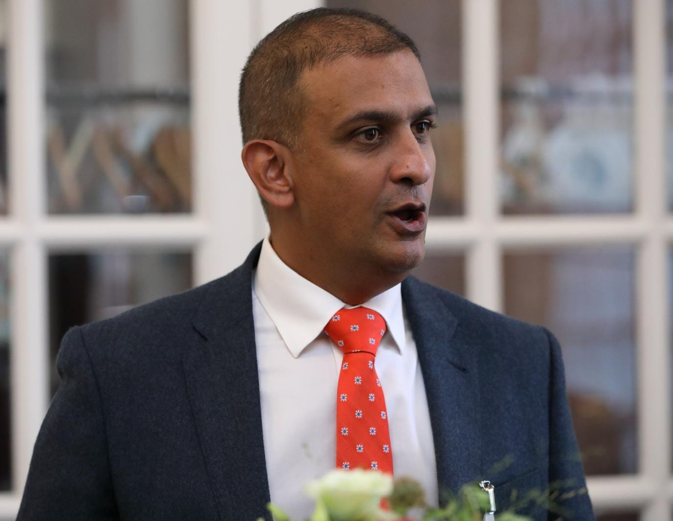 Professor Khan speaking at an event